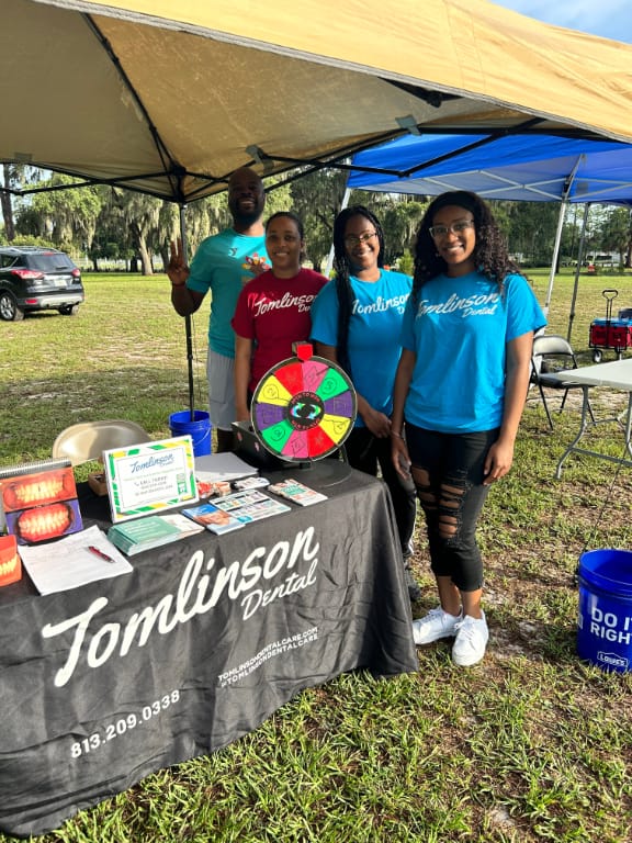 Staff at booth with games, inforamtion, and prizes