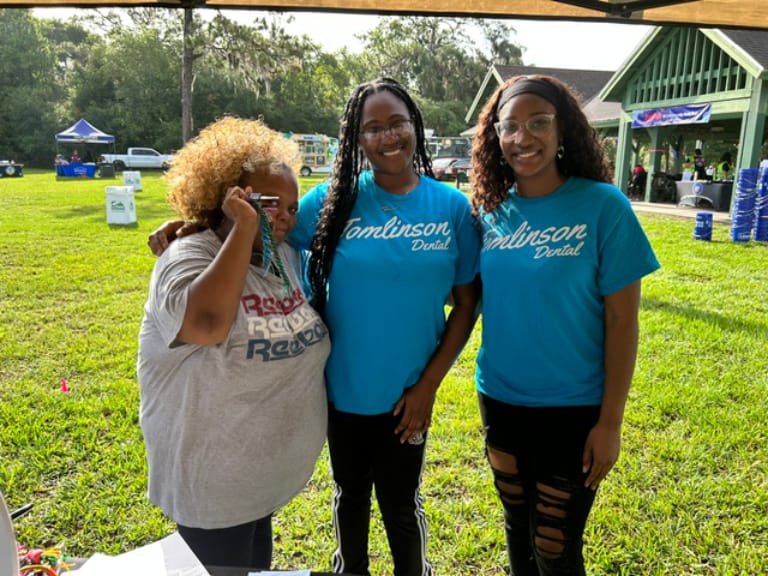 Staff posing with a race participant