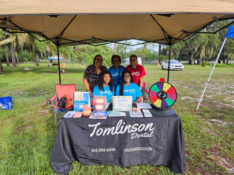 Staff at booth with games, inforamtion, and prizes