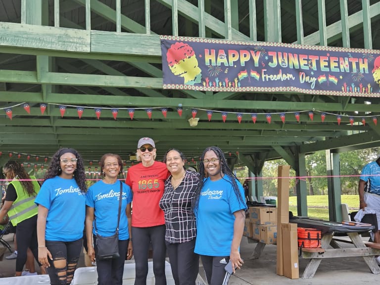 Staff posing with a race participant