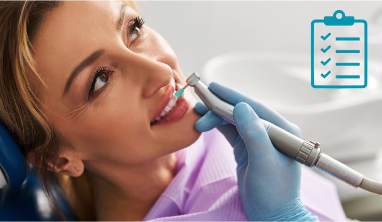 A woman receives a dental cleaning from her dentist, showcasing a routine check-up for maintaining oral health.